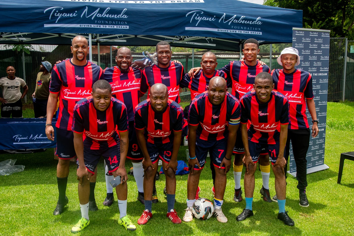Sponsored soccer squad in matching strip