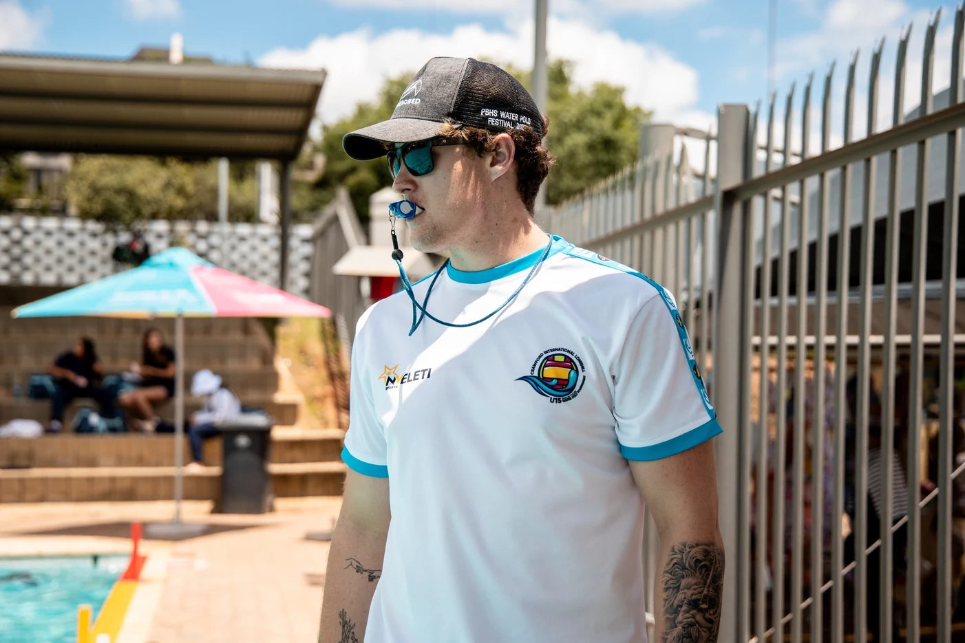 Swimming coach in branded team shirt